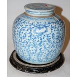 A 19th century Chinese stoneware blue and white ginger jar and cover, of typical bulbous form,