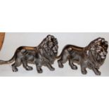 A pair of modern silvered metal figures of lions, each in standing pose, h.