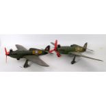 A pair of plastic petrol powered miniature model aircraft in the form of Supermarine Spitfires,