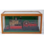 Horizontal mill engine in sealed glass display case.