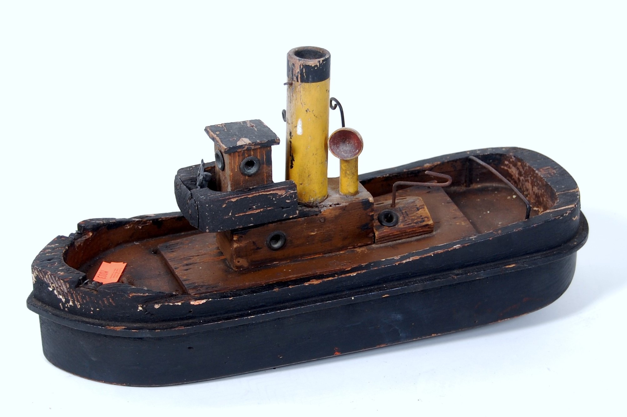 Early 20th century clockwork tug boat, hull hollowed out wood, prop shaft missing,