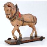 An early 20th century, possibly German, composition model of a pull-along horse,