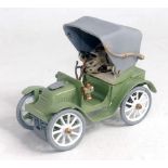 An early Pound Toy, finished in green and grey with white spoked wheels, weights exactly 1 pound,