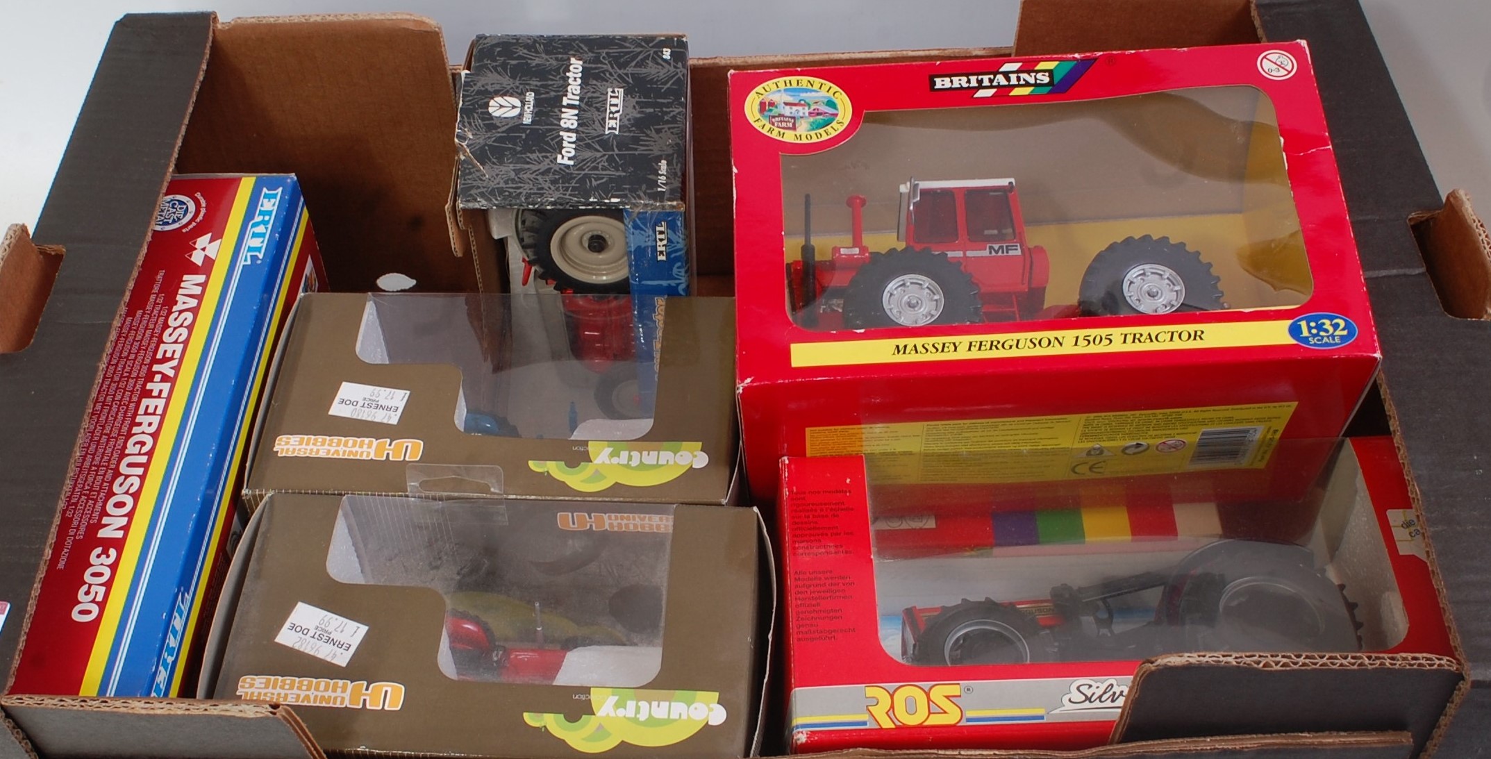 Eight various boxed Britains, Universal Hobbies, and Ertl mixed scale farming diecast,