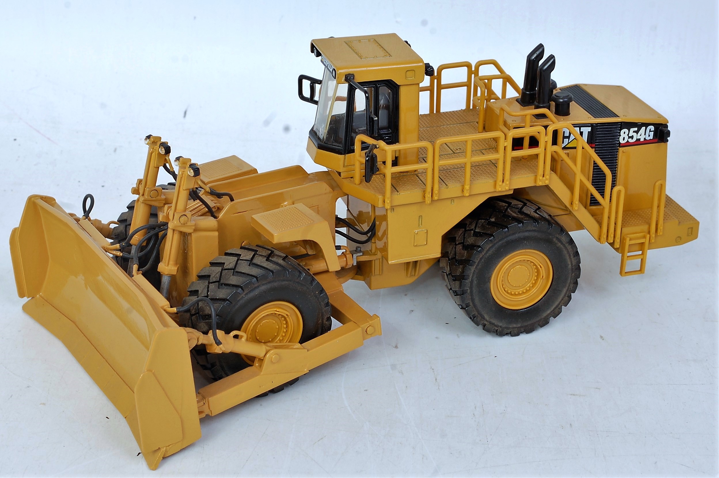 An OHS white metal and diecast model of a Caterpillar 854G wheeled bulldozer