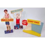 Three various original Hornby, Meccano and Dinky Toys shop advertising cards,