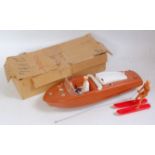 A Geshca of Germany plastic and battery operated motorboat finished in brown and white with driver,