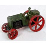 An early Tootsie Toys farm tractor, comprising black, green and red,