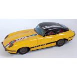 A TT Toys of Japan tinplate and friction drive model of a Jaguar GTX 753 tinprinted in yellow and