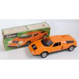 A Shuco plastic and battery operated model of a Mercedes C111 racing car comprising orange and