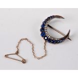 A sapphire and diamond crescent brooch,