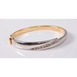 An 18ct bi-coloured diamond hinged bangle by Sade Is,