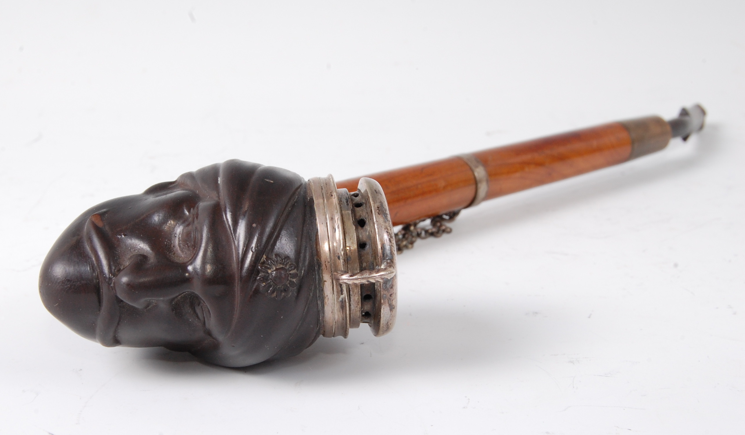 A mid-19th century German pipe, the brown stoneware bowl modelled as a 'Turks head',
