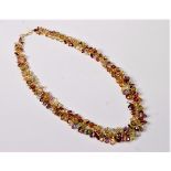 A multi gemset necklace, the graduated oval faceted gemstones including garnet, amethyst, citrine,