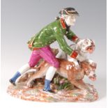 A late 19th century Dresden porcelain group modelled as a huntsman with hounds,