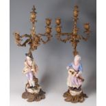 A pair of mid-19th century Rococo Revival gilt brass four light candelabra,
