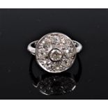 An 18ct diamond target ring, the central round brilliant cut diamond in a rubover mount,
