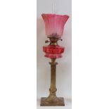 A late Victorian brass pedestal oil lamp,