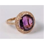 An amethyst and diamond ring, the round amethyst approx. 11.