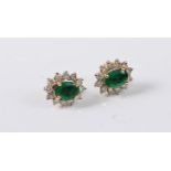 A pair of 18ct emerald and diamond earstuds, the oval emeralds, approx. 6.