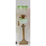 A late Victorian embossed brass pedestal oil lamp,