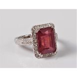 A treated ruby and diamond ring, the emerald cut ruby approx. 11.9 x 8.