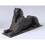 An Egyptian Revival bronze Sphinx, on rectangular plinth, decorated with hieroglyphics,
