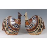 A pair of large contemporary Perisan stoneware models of seated hens,