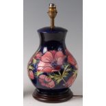 A modern Moorcroft pottery table lamp in the Anemone pattern, of lower bulbous form,