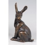 A contemporary lacquered bronze model of a seated hare, with incised detail, indistinct stamp verso,