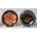An early 20th century Moorcroft pottery circular footed dish in the Hibiscus pattern,