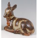 Knud Kyhn (1880-1969) for Royal Copenhagen - A glazed stoneware model of a recumbent deer,