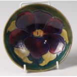 An early 20th century Moorcroft pottery footed circular bowl in the Clematis pattern,