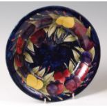 An early 20th century Moorcroft Plum pattern pottery circular fruit bowl,