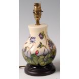 A modern Moorcroft pottery lamp in the Ashwood Hepatica pattern, by Emma Bossons,