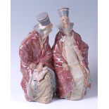 A Lladro glazed pottery figure group of two seated scholars,