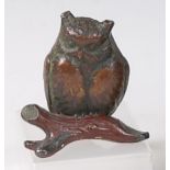 An early 20th century cold painted bronze model of an owl perched on a branch, unsigned, h.7.