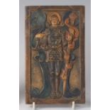 A Compton Pottery relief pottery wall plaque of St Michael the Archangel, painted in muted tones,