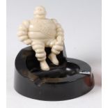 A Michelin bakelite ashtray, modelled as a seated Mr Bibendum, with raised mark Made in USA verso,