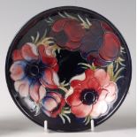 An early 20th century Moorcroft pottery circular footed comport in the Anemone pattern,