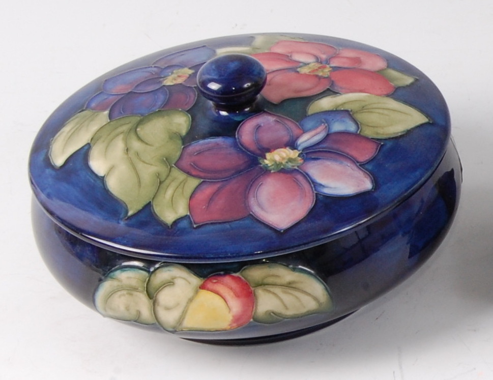 An early 20th century Moorcroft pottery circular lidded bowl in the Clematis pattern,