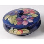 An early 20th century Moorcroft pottery circular lidded bowl in the Clematis pattern,