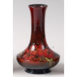 An early 20th century Moorcroft pottery vase in the Flambé Orchid pattern,