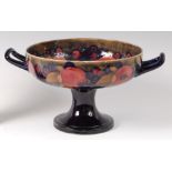 An early 20th century Moorcroft Pomegranate pattern pottery twin handled footed fruit bowl,