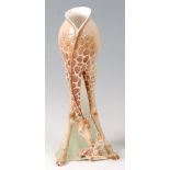 A Franz giraffe ceramic vase, of baluster form, modelled with a recumbent baby giraffe at base,
