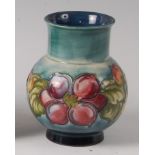 An early 20th century Moorcroft pottery squat vase in the Clematis pattern, of lower bulbous form,
