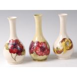 A mid-20th century Moorcroft pottery slender necked bottle vase in the Hibiscus pattern,