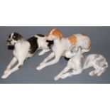A Lomonosov Russian black and white glazed porcelain model of a dog in recumbent pose,