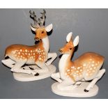 A pair of Lomonosov porcelain models of a deer and doe, each in recumbent pose,