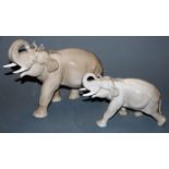 A Lomonosov Russian porcelain figure of an elephant in striding pose together with a calf,